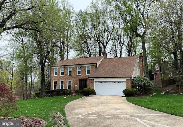 11919 Berrybrook Ter, Upper Marlboro, MD 20772 - colonial house featuring brick siding, concrete driveway, a front lawn, and an attached garage