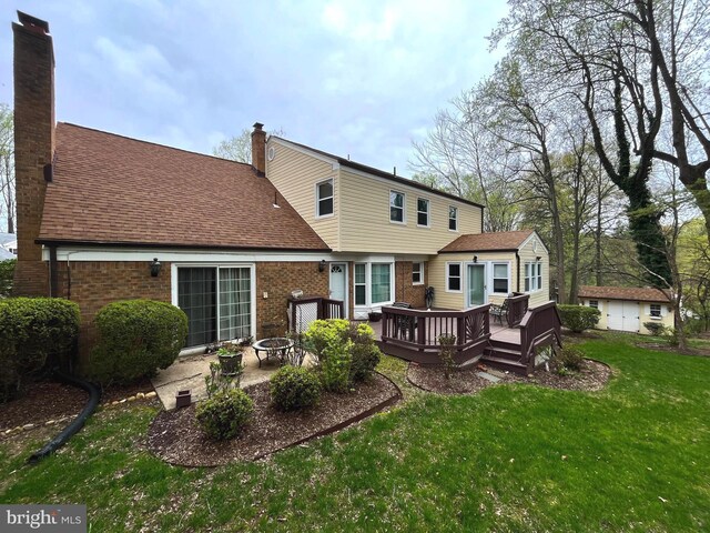 11919 Berrybrook Ter, Upper Marlboro, MD 20772 - back of house with a fire pit, a yard, a deck, and a chimney