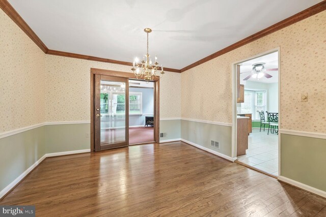 11919 Berrybrook Ter, Upper Marlboro, MD 20772 - empty room with plenty of natural light, ornamental molding, wood finished floors, a chandelier, and wallpapered walls
