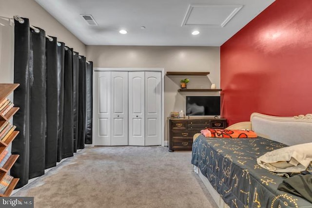 bedroom featuring a closet and light carpet