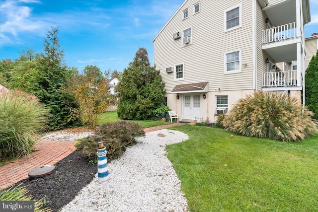 rear view of property with cooling unit and a lawn