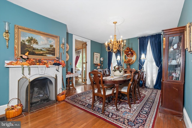 dining room with hardwood / wood-style flooring and a chandelier