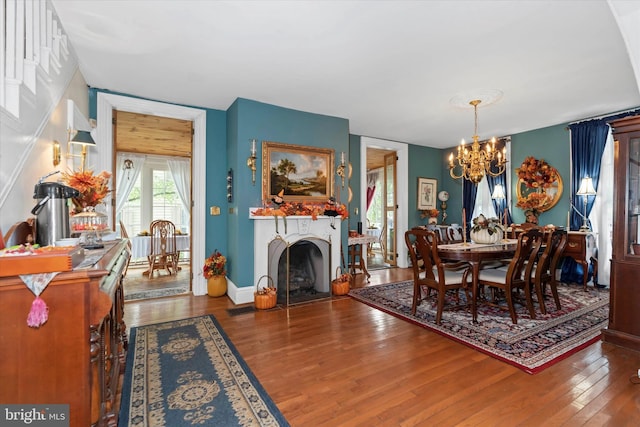 dining room with wood-type flooring and a chandelier