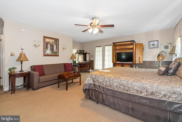 carpeted bedroom with ornamental molding, ceiling fan, and french doors