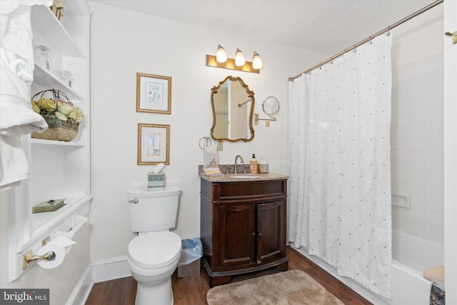 full bathroom with shower / tub combo, hardwood / wood-style floors, vanity, a textured ceiling, and toilet