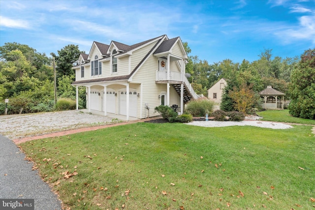 view of front of house featuring a gazebo, a garage, and a front lawn