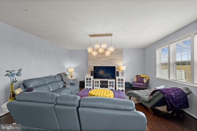 living room with a notable chandelier and dark wood-type flooring