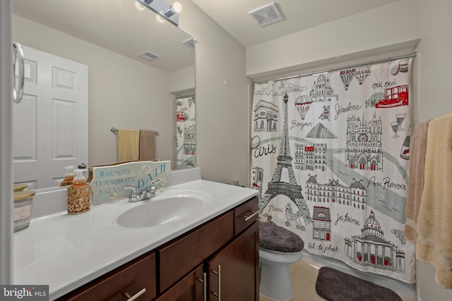 bathroom with vanity, toilet, and a shower with shower curtain