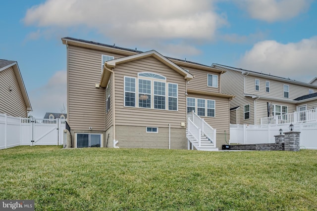 rear view of property with a yard