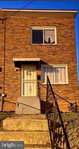 back of house featuring brick siding