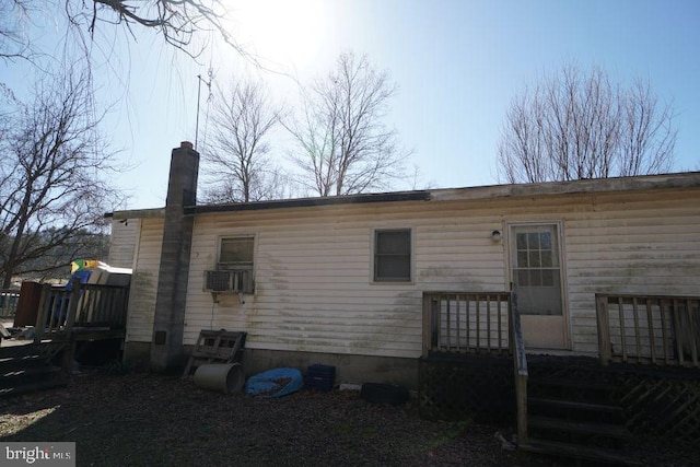 rear view of house featuring a chimney