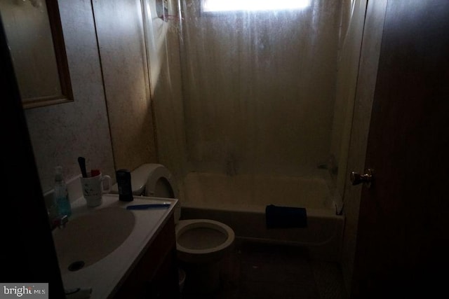 full bathroom with shower / bath combo, a sink, and toilet