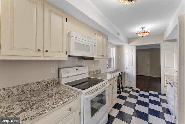 kitchen featuring white appliances and light stone counters