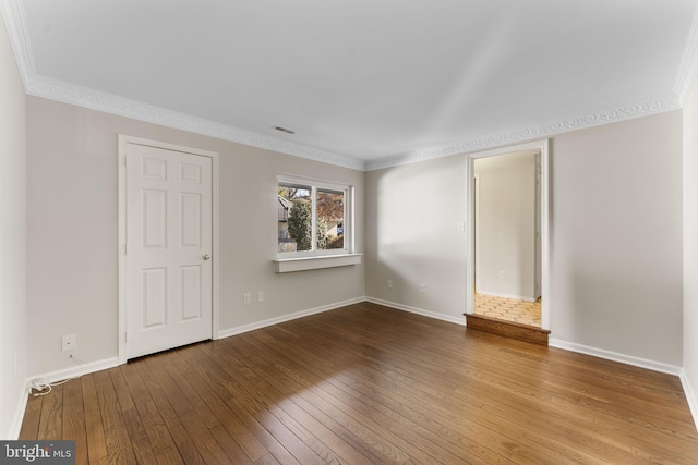 unfurnished bedroom featuring hardwood / wood-style flooring and ornamental molding