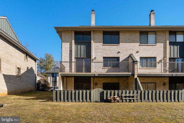 rear view of property featuring a yard