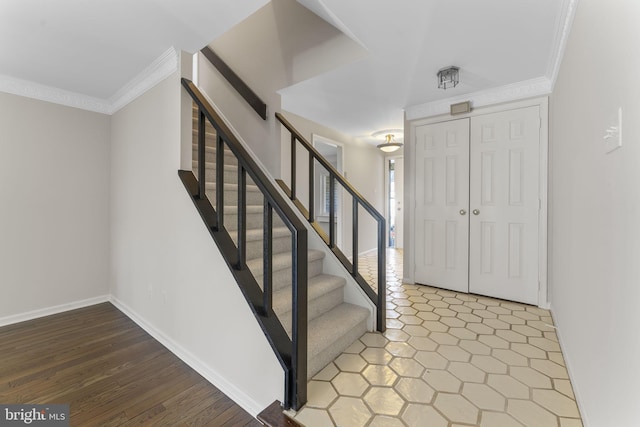 entrance foyer with hardwood / wood-style flooring and crown molding