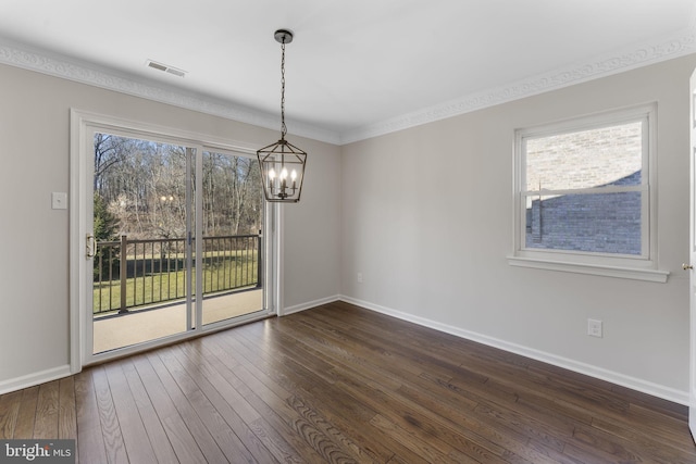 unfurnished dining area featuring a wealth of natural light, crown molding, an inviting chandelier, and dark hardwood / wood-style flooring