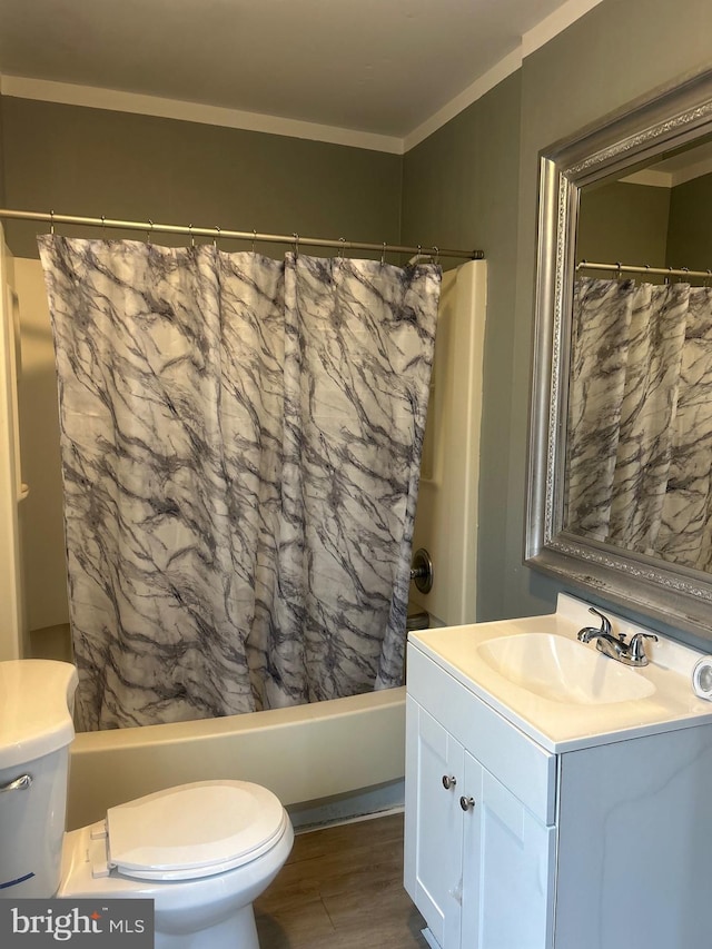 full bathroom with hardwood / wood-style flooring, vanity, ornamental molding, toilet, and shower / bathtub combination with curtain