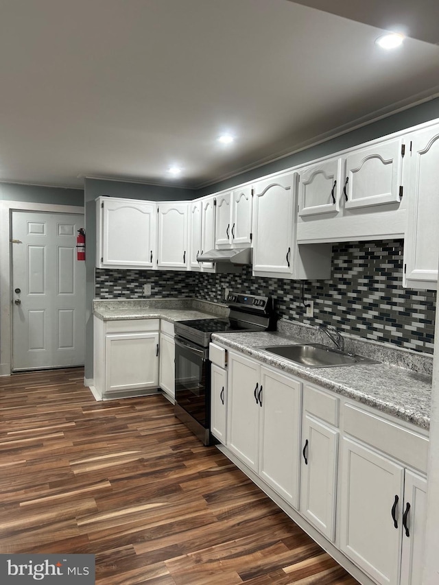 kitchen with dark hardwood / wood-style floors, tasteful backsplash, sink, white cabinets, and black range with electric stovetop