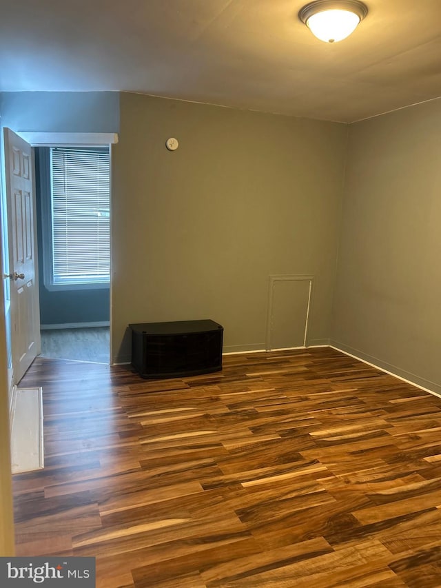 unfurnished room with dark hardwood / wood-style floors