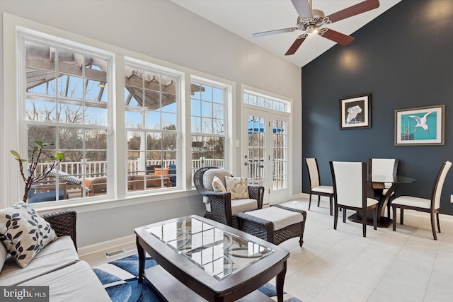 sunroom / solarium featuring ceiling fan, french doors, vaulted ceiling, and visible vents