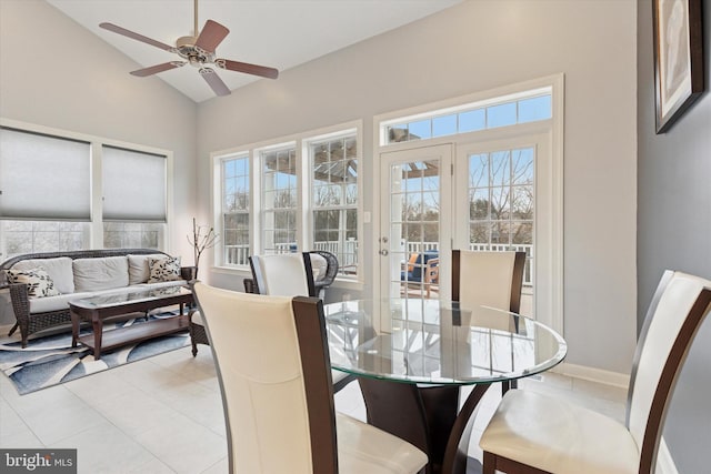 sunroom featuring lofted ceiling, ceiling fan, and plenty of natural light