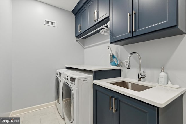 clothes washing area featuring cabinet space, light tile patterned floors, visible vents, washer and clothes dryer, and a sink