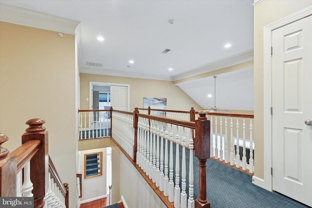 corridor with visible vents, ornamental molding, and an upstairs landing