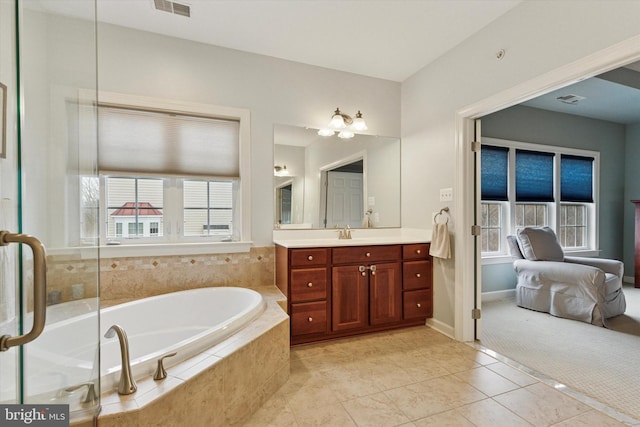 bathroom with visible vents, a garden tub, vanity, and tile patterned floors