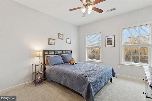 carpeted bedroom with baseboards and visible vents