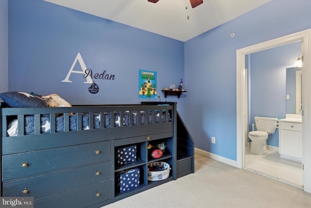 bedroom with a ceiling fan, carpet, baseboards, and ensuite bathroom