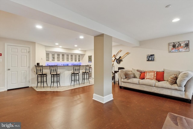 living room featuring recessed lighting, baseboards, and a dry bar