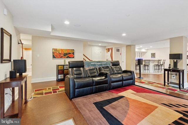 living room featuring baseboards, stairway, and recessed lighting