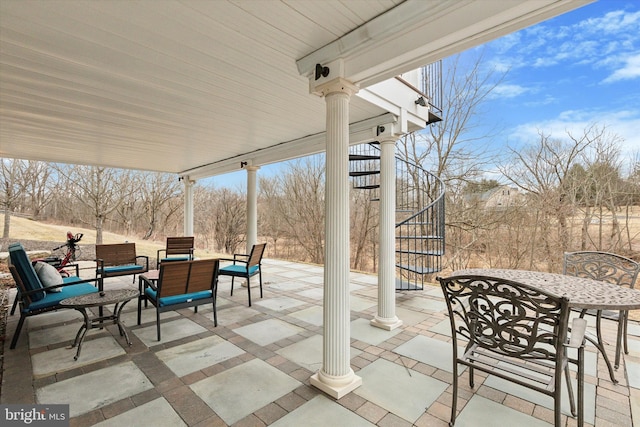 view of patio / terrace featuring outdoor dining space and stairway