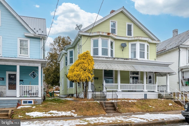 victorian house featuring a porch