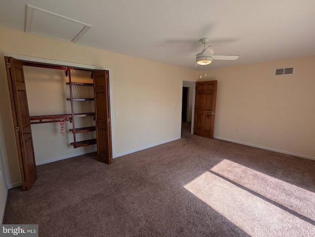 unfurnished bedroom with ceiling fan, carpet flooring, and a closet