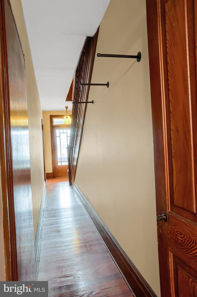 corridor with hardwood / wood-style flooring