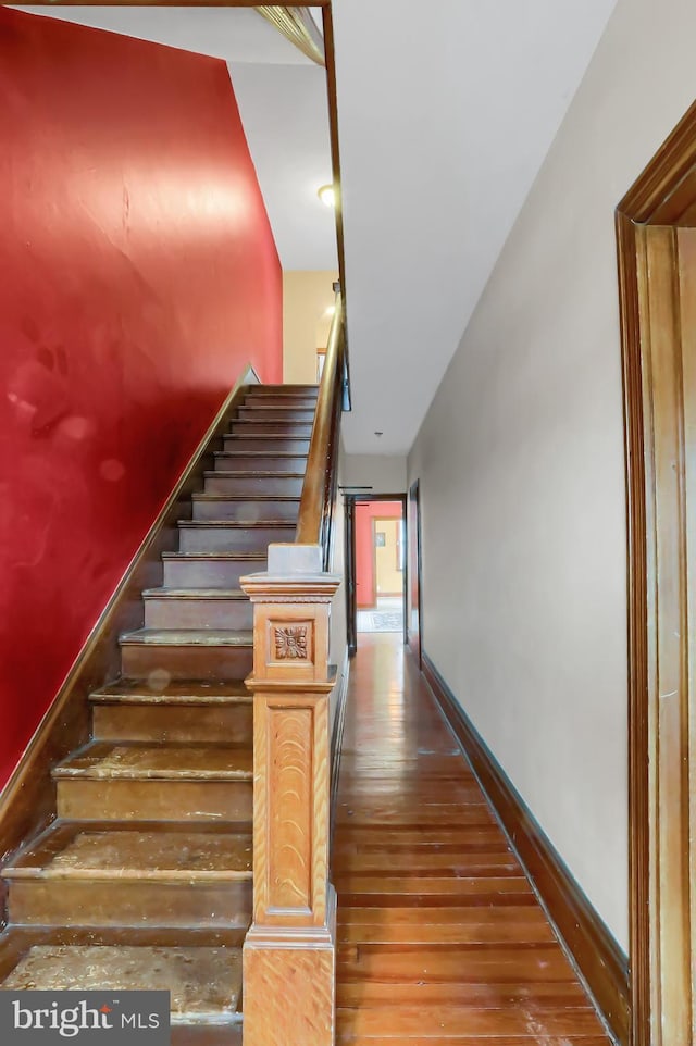 stairway featuring hardwood / wood-style flooring