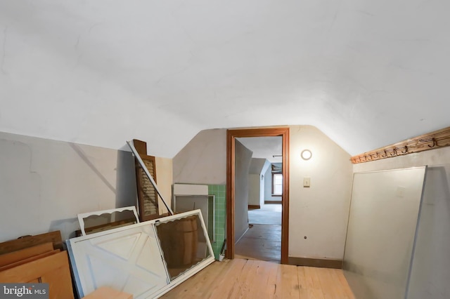 bonus room featuring lofted ceiling and light hardwood / wood-style flooring