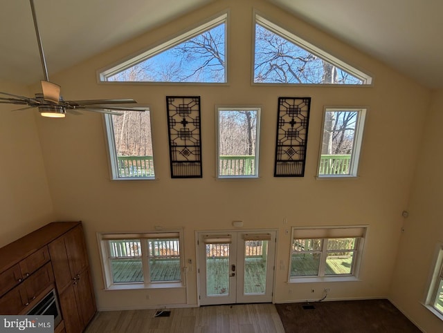 interior space with wood-type flooring, french doors, and ceiling fan