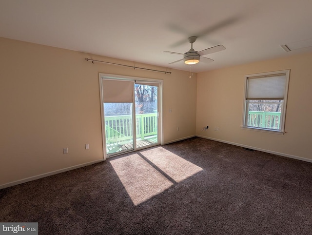 spare room featuring ceiling fan and dark colored carpet