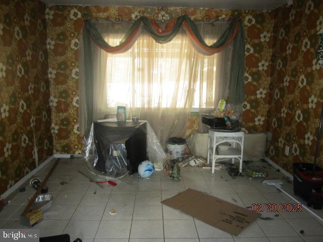 unfurnished dining area with plenty of natural light and tile patterned flooring