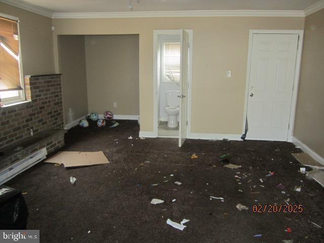 interior space with baseboards and ornamental molding