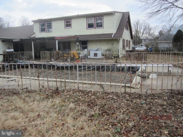 back of house with fence