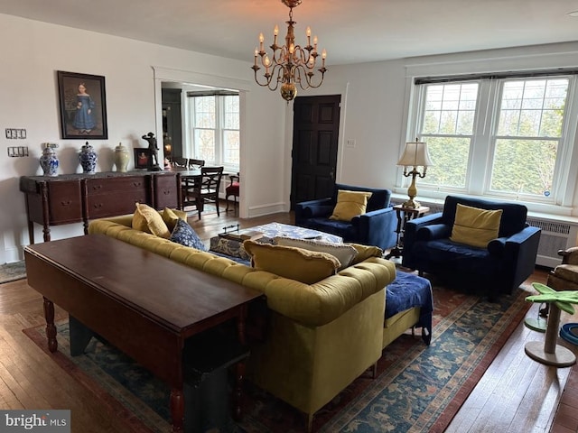 living room featuring radiator, a notable chandelier, and dark hardwood / wood-style flooring