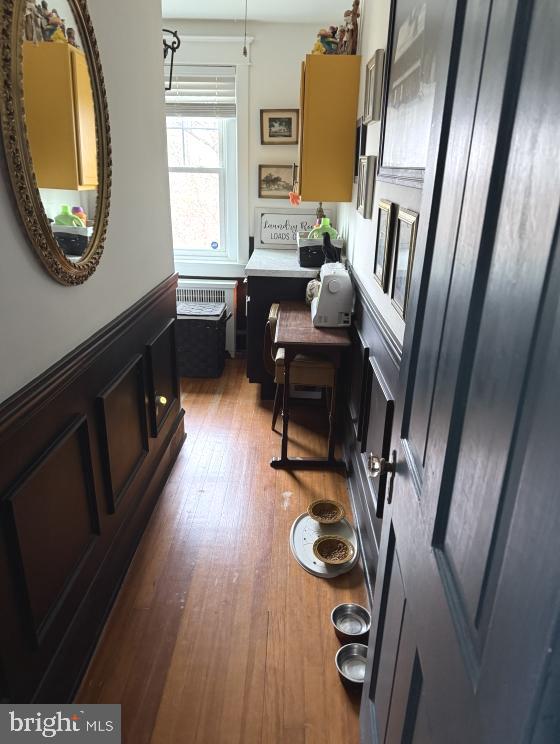 interior space featuring radiator heating unit and hardwood / wood-style floors