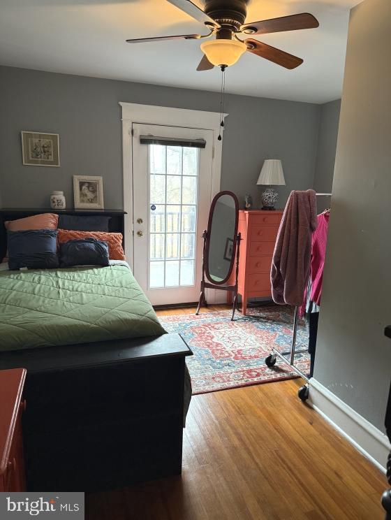 bedroom featuring hardwood / wood-style floors, access to exterior, and ceiling fan