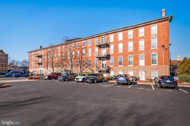 view of building exterior with uncovered parking