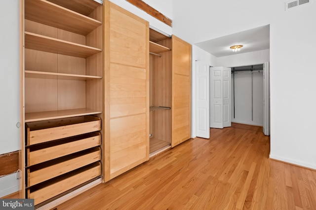 spacious closet with light wood-type flooring and visible vents