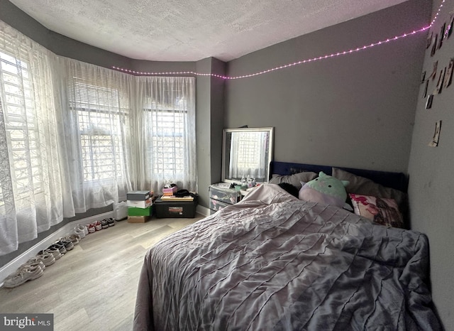 bedroom featuring wood-type flooring and a textured ceiling